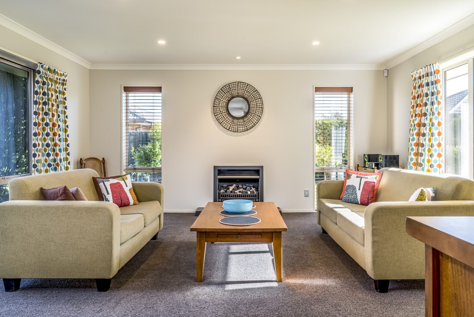 The living room of a modern apartment with two identical sofas opposite each other