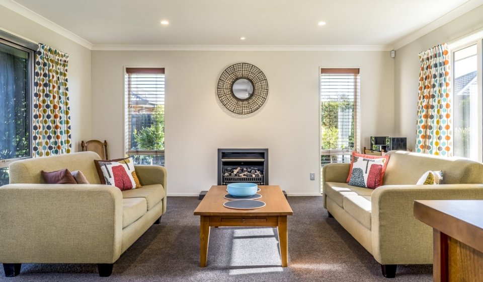 The living room of a modern apartment with two identical sofas opposite each other